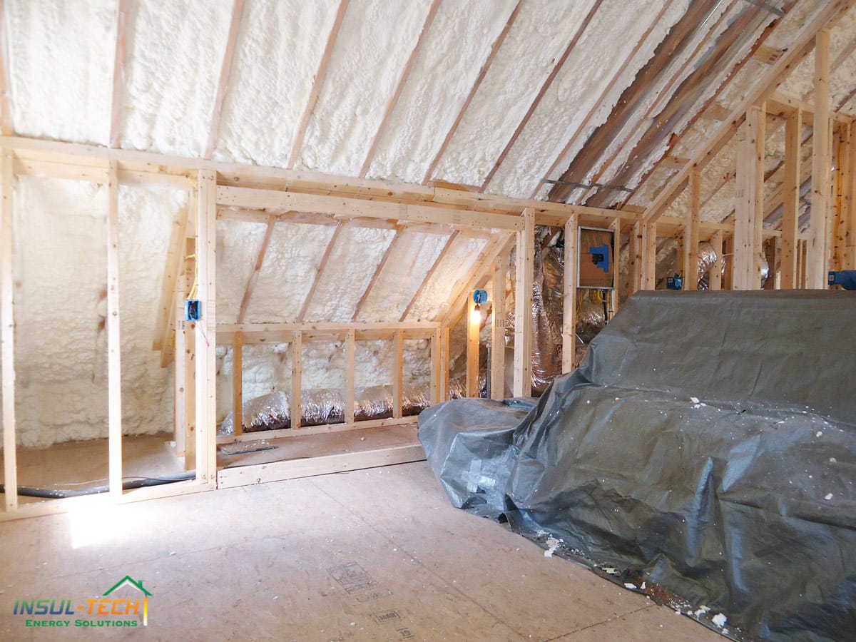 A close up of an angled ceiling and walls with spray foam insulation